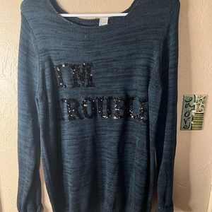 Dark emerald green and black sweater with “IM Trouble” in black sequins size S/M